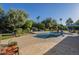 Backyard pool with mature landscaping, stone accents and adjacent playground at 7471 E Northern Ave, Scottsdale, AZ 85258