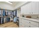 Spacious walk-in closet with custom shelving, cabinets, drawers and ample storage for clothes and accessories at 7471 E Northern Ave, Scottsdale, AZ 85258