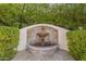 Stone water feature surrounded by lush greenery and mature landscaping at 7471 E Northern Ave, Scottsdale, AZ 85258