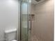 Shower with decorative tile and glass door at 7760 E Pepper Tree Ln, Scottsdale, AZ 85250