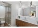 Modern bathroom featuring a vanity with drawers, decorative lighting, and glass shower enclosure at 7760 E Pepper Tree Ln, Scottsdale, AZ 85250