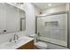 Bright bathroom with modern fixtures, a shower-over-tub, and a decorative mirror at 7760 E Pepper Tree Ln, Scottsdale, AZ 85250