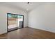 Bright bedroom with wood floors, an outside patio, and a sliding glass door at 7760 E Pepper Tree Ln, Scottsdale, AZ 85250