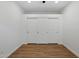 Bedroom featuring hardwood floors and a large closet with white doors at 7760 E Pepper Tree Ln, Scottsdale, AZ 85250