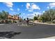Beautiful community entrance featuring lush landscaping, mature trees, and a grand fountain at 7760 E Pepper Tree Ln, Scottsdale, AZ 85250