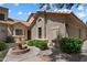 Charming home exterior featuring a beautiful water fountain, lush greenery, and a well-maintained facade at 7760 E Pepper Tree Ln, Scottsdale, AZ 85250