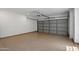 Spacious garage with sealed floors and a garage door at 7760 E Pepper Tree Ln, Scottsdale, AZ 85250