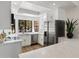 Bright kitchen featuring white cabinets, quartz countertops, stainless steel appliances and a bay window at 7760 E Pepper Tree Ln, Scottsdale, AZ 85250