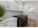 A modern laundry room with cabinets and countertops at 7760 E Pepper Tree Ln, Scottsdale, AZ 85250