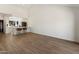 Spacious living room that leads to a modern kitchen with barstool seating and hardwood floors at 7760 E Pepper Tree Ln, Scottsdale, AZ 85250