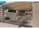 Covered patio with ample seating, providing shade and relaxation by the pool at 7760 E Pepper Tree Ln, Scottsdale, AZ 85250