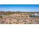 Wide aerial shot of a community featuring desert landscape, water features, and mountain views under a clear sky at 7931 W Harmony Ln, Peoria, AZ 85382