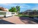 Spacious backyard with brick pavers, lush greenery, perfect for outdoor relaxation and entertaining at 7931 W Harmony Ln, Peoria, AZ 85382