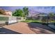 Spacious backyard with brick pavers, lush greenery, perfect for outdoor relaxation and entertaining at 7931 W Harmony Ln, Peoria, AZ 85382
