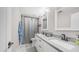 Updated bathroom with a double sink vanity and modern fixtures at 7931 W Harmony Ln, Peoria, AZ 85382