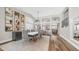 Elegant dining room with hardwood floors, a modern chandelier, and decorative wall art at 7931 W Harmony Ln, Peoria, AZ 85382