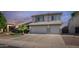 Charming two-story home featuring a well-manicured lawn, palm tree, and a convenient two-car garage at 7931 W Harmony Ln, Peoria, AZ 85382