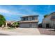 Charming two-story home featuring a well-manicured lawn, palm tree, and a convenient two-car garage at 7931 W Harmony Ln, Peoria, AZ 85382