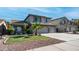 Charming two-story home featuring a well-manicured lawn, palm tree, and a convenient two-car garage at 7931 W Harmony Ln, Peoria, AZ 85382