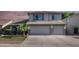 Charming two-story home featuring a well-manicured lawn, palm tree, and a convenient two-car garage at 7931 W Harmony Ln, Peoria, AZ 85382