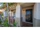 Inviting covered front porch with a secure black metal screen door and cozy seating area at 7931 W Harmony Ln, Peoria, AZ 85382