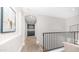 Carpeted upstairs hallway with storage and a modern handrail at 7931 W Harmony Ln, Peoria, AZ 85382