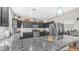 Modern kitchen with dark cabinetry, stainless steel appliances, granite countertops and a breakfast bar at 7931 W Harmony Ln, Peoria, AZ 85382