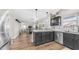 Open kitchen with dark cabinets, granite countertops, stainless steel appliances, vinyl flooring at 7931 W Harmony Ln, Peoria, AZ 85382