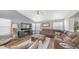 Cozy living room with a large sectional sofa, shiplap wall, and ample natural light at 7931 W Harmony Ln, Peoria, AZ 85382