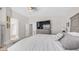 Bright main bedroom with neutral colors, vaulted ceiling, plush carpet flooring, and a large television at 7931 W Harmony Ln, Peoria, AZ 85382