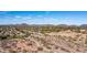 Aerial view of a desert neighborhood showcasing a trail, lake, and mountain backdrop at 7931 W Harmony Ln, Peoria, AZ 85382