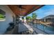 Large covered patio with ceiling fans, wood ceiling, dining table, and outdoor kitchen at 7931 W Harmony Ln, Peoria, AZ 85382