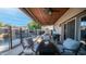 Comfortable outdoor seating area with fire table, ceiling fans, covered patio, and view of the pool at 7931 W Harmony Ln, Peoria, AZ 85382
