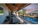 Large covered patio with ceiling fans, wood ceiling, dining table, and outdoor kitchen at 7931 W Harmony Ln, Peoria, AZ 85382