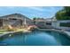 Backyard pool with waterfall feature, lounge chair, and privacy wall at 7931 W Harmony Ln, Peoria, AZ 85382