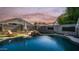 Backyard pool with waterfall feature, lounge chair, and privacy wall at 7931 W Harmony Ln, Peoria, AZ 85382