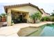 Charming backyard featuring a pool, covered patio, and mature palm trees at 8341 W Gross Ave, Tolleson, AZ 85353