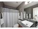 Bathroom featuring a vessel sink, tile, and shower with patterned curtain at 8341 W Gross Ave, Tolleson, AZ 85353