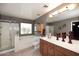 Bathroom featuring a shower, tub, window, and vanity with light wood cabinets at 8341 W Gross Ave, Tolleson, AZ 85353
