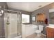 Bathroom featuring a tiled shower and separate tub under a frosted window at 8341 W Gross Ave, Tolleson, AZ 85353