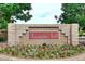 Community entrance sign with manicured landscaping and vibrant floral display at 8341 W Gross Ave, Tolleson, AZ 85353