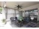 Relaxing covered patio area with cozy seating, ceiling fan, and privacy screens at 8341 W Gross Ave, Tolleson, AZ 85353
