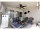 Inviting covered patio with comfortable seating, ceiling fan, and stylish decor at 8341 W Gross Ave, Tolleson, AZ 85353