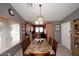 Dining room with chandelier and an open view to the kitchen at 8341 W Gross Ave, Tolleson, AZ 85353