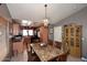 Dining room showing table, chairs, and chandelier, with a view of the kitchen at 8341 W Gross Ave, Tolleson, AZ 85353