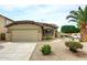 Charming home featuring a two-car garage, desert landscaping, and a mature palm tree in the front yard at 8341 W Gross Ave, Tolleson, AZ 85353