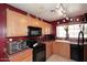 Kitchen featuring ample wooden cabinets and black appliances at 8341 W Gross Ave, Tolleson, AZ 85353