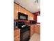 Well-lit kitchen with ample cabinet space, black appliances, and warm, inviting decor at 8341 W Gross Ave, Tolleson, AZ 85353