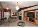 Cozy living room with a fireplace, TV, and chandelier at 8341 W Gross Ave, Tolleson, AZ 85353