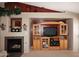 Living room featuring a fireplace, entertainment center, and neutral paint at 8341 W Gross Ave, Tolleson, AZ 85353
